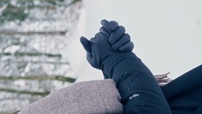 Close up of woman heating hands in a cold winter by rubbing them