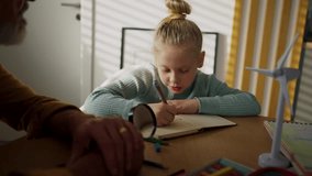 Senior man doing homework with his granddaughter. - Powered by Shutterstock - Get 15% off with code: PIKWIZARD15