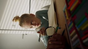 Vertical view of a senior man doing homework with his granddaughter. - Powered by Shutterstock - Get 15% off with code: PIKWIZARD15