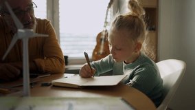 Senior man doing homework with his granddaughter. - Powered by Shutterstock - Get 15% off with code: PIKWIZARD15