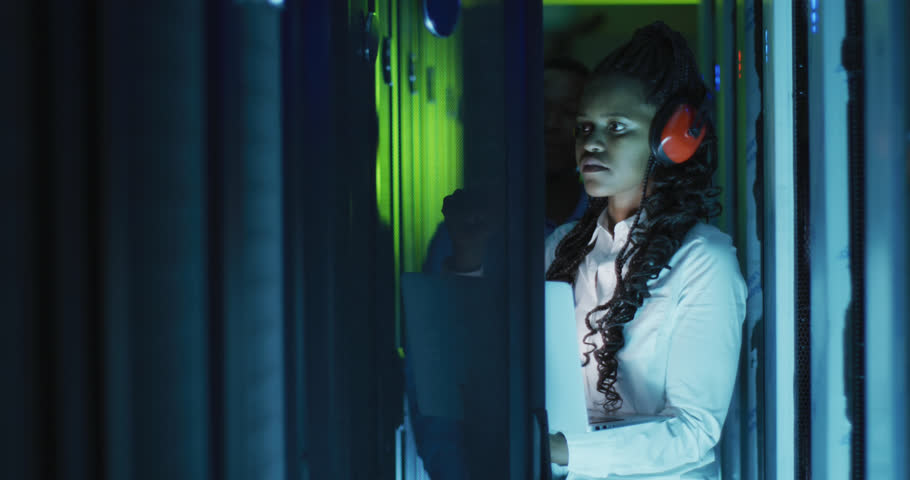 Animation of ai text, icons and female african american it engineer and computer servers. Artificial intelligence, digital interface, computing and data processing concept digitally generated video.