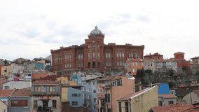 Video of the city from a cafe in istanbul balat. flying seagull in the air. Balat Red Church in the background.