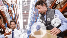 Animation of connected icons over diverse coworkers working in warehouse. Digital composite, multiple exposure, communication, packaging, abstract, teamwork and distribution concept, - Powered by Shutterstock - Get 15% off with code: PIKWIZARD15