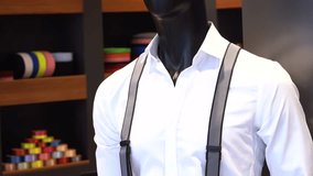 Model young man in white shirt and suspenders and knitted belt. 4K video shooting.