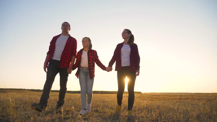 Happy family day.Family walks in field in nature with child. Happy family with child at sunset in summer. Family summer trip. Happy trip in nature. Royalty-Free Stock Footage #1102327459