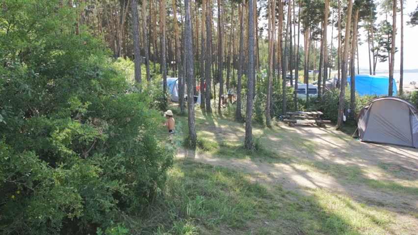 Sand beach with camping on the river Yenisei shore. Nature landscape. Krasnoyarsk reservoir, Anashensky forest (Novoselovo area, Krasnoyarski krai, Siberia, Russia). Panning right. July 25, 2015.