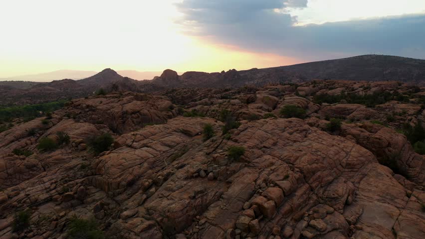 Aerial view low over rocky nature at Watson lake, sunset in Prescott, Arizona