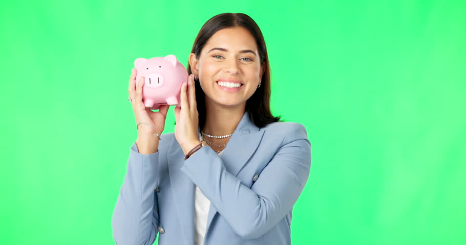 Business woman, money and piggy bank on green screen for savings, budget or finance against studio background. Portrait of happy female smile holding cash for coin, profit or investment on mockup