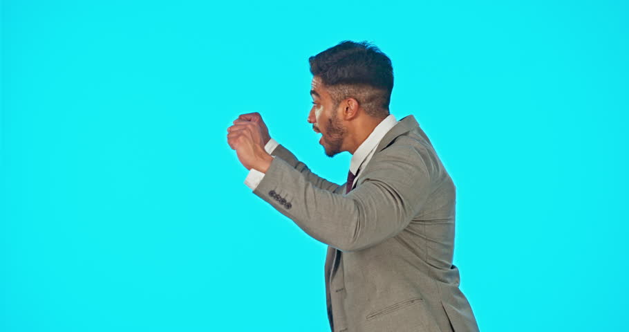 Speaker, loud and businessman shouting on a megaphone making an announcement isolated in a blue studio background. Frustration, audio and screaming man speaking on a voice broadcast or speech
