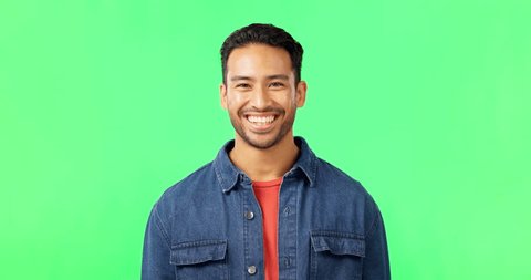 Man, laughing and portrait on green screen in studio with space for comic joke and funny emoji. Face of asian male model person laugh for happiness or positive mindset on chroma key background स्टॉक व्हिडिओ