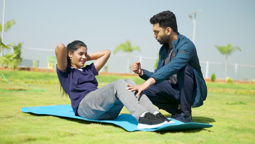 Fitness trainer encouraging or cheering up woman for exercising by pushing up limits - concept of motivation, guidance and athletic Royalty-Free Stock Footage #1102356351