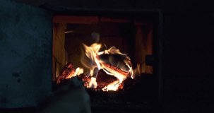 4K close-up video of burning fire in fireplace in a small countryside house