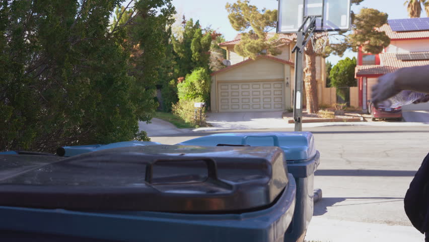 Man throwing garbage in the trash can. Separation of waste into waste and recycling