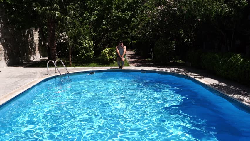 Man jumping into the pool like a cannonball