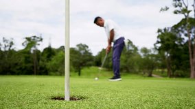 Golfer putting ball on the green golf, lens flare on sun set evening time. Blurred golfer playing golf in beautiful golf course in the evening golf course with sunshine.  - Powered by Shutterstock - Get 15% off with code: PIKWIZARD15