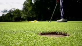 Golfer putting ball on the green golf, lens flare on sun set evening time. Blurred golfer playing golf in beautiful golf course in the evening golf course with sunshine.  - Powered by Shutterstock - Get 15% off with code: PIKWIZARD15