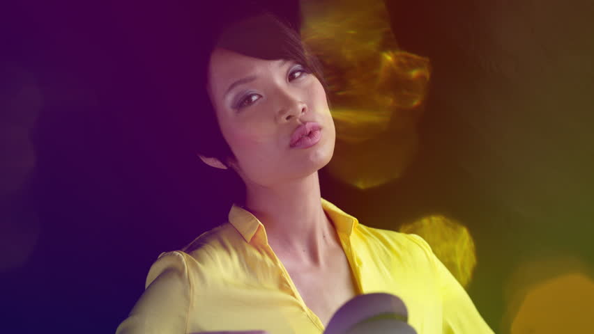 Beautiful asian female model posing and dancing with fan in lifestyle scene
