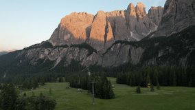 Aerial video over the Dolomites mountain range, at sunset. Northern Italy Tyrol