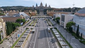 Aerial long view of Avinguda de la Reina Maria Cristina at its junction with Montjuic Palace in background. This iconic square is located at foot of Montjuic major landmark in Barcelona. 4K video.