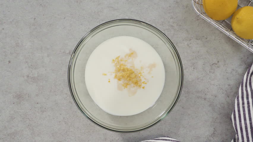 Flat lay. Ingredients in a glass mixing bowls to bake a lemon pound cake.
