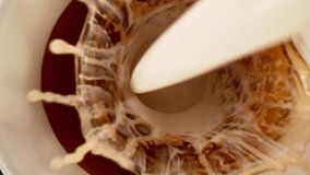 Camera Follows. Super Slow Motion Shot of Pouring Milk into Tea on Stone Background at 1000 fps - Powered by Shutterstock - Get 15% off with code: PIKWIZARD15