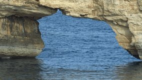 Video of stone arch Kamara and coastal rocks in the sea near Geropotamos beach on Crete, Greece, Rethymno prefecture.
