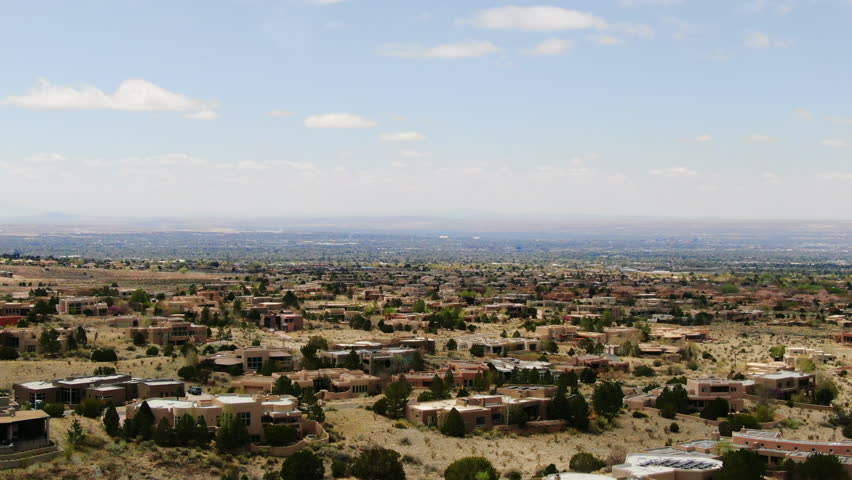 Adobe Homes dolly down aerial drone Sandia Mountains Albuquerque New Mexico