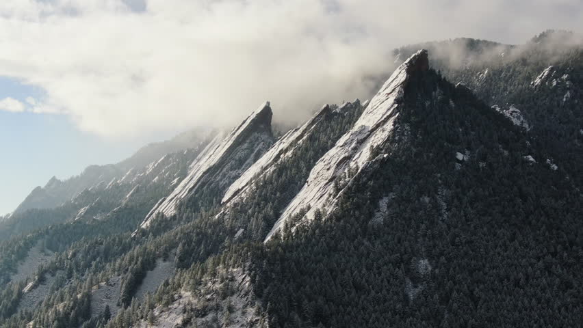Early morning sunrise boulder Flat Irons hiking trails with snow Chautauqua hiking trails drone forward motion Colorado