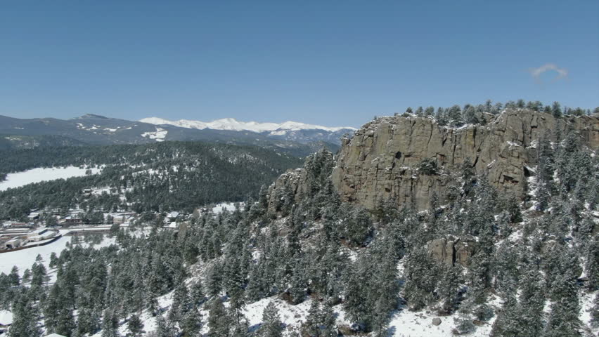 Winter scene Rocky Mountains Colorado snowy tree up zoom toward Mt Evans Blue Sky Evergreen 14er mountain range Denver