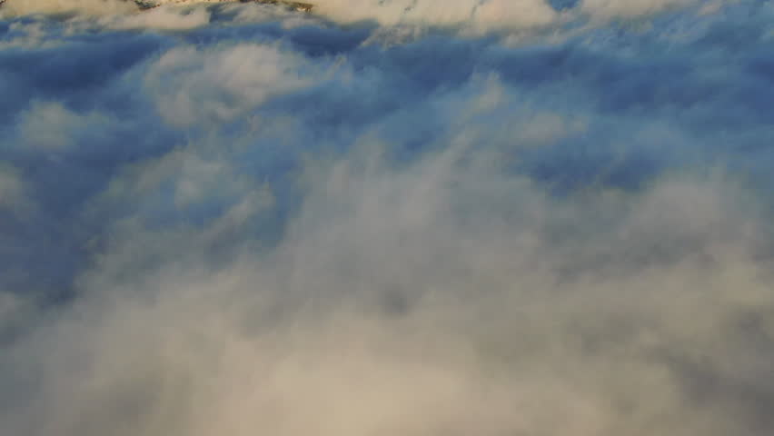 Wave of clouds Pan up sunrise above the clouds flying Boulder Flat Irons freezing cold winter orange drone aerial Colorado
