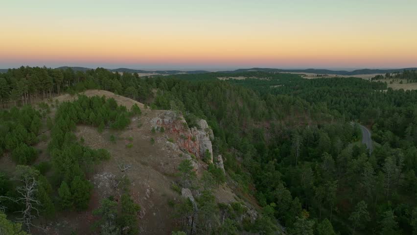 Orbiting aerial view of a rocky mountain top in South Dakota