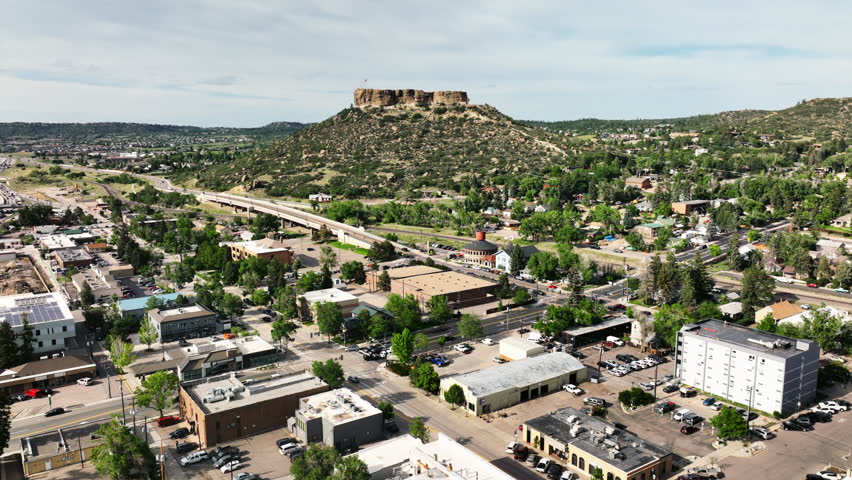 Downtown Castle Rock Colorado pan left slide movement summer green beautiful cars people
