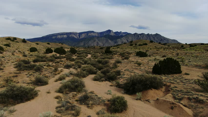 Mountain Trail hike drone aerial forward towards the Sandia Mountains Albuquerque New Mexico