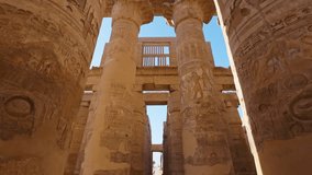 Karnak Temple in Luxor, Egypt. Camera moves between majestic columns with ancient Egyptian drawings. Gimbal high quality shot - Powered by Shutterstock - Get 15% off with code: PIKWIZARD15