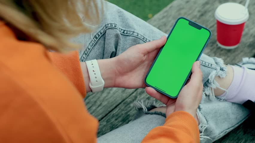Young Woman Using Smartphone in Vertical Mode with Green Mock-up Screen Outside, Doing Swiping, Scrolling Gestures. Internet Social Networks Browsing News, Financial Reports Royalty-Free Stock Footage #1102389639