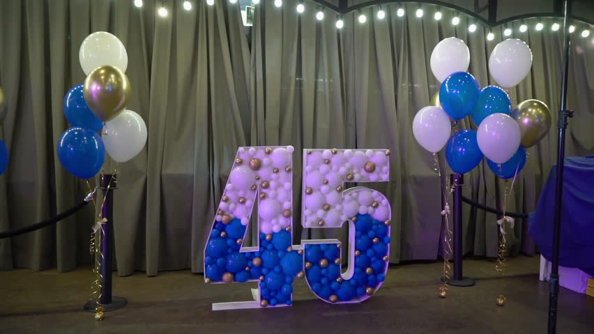 Balloons at the party decorated. White and blue round ballon. 45 years old party birthday celebration. Bday party indoors. Anniversary.