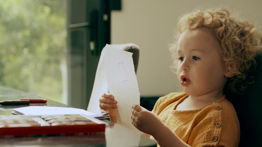 Funny artistic little girl pretends to read a poem