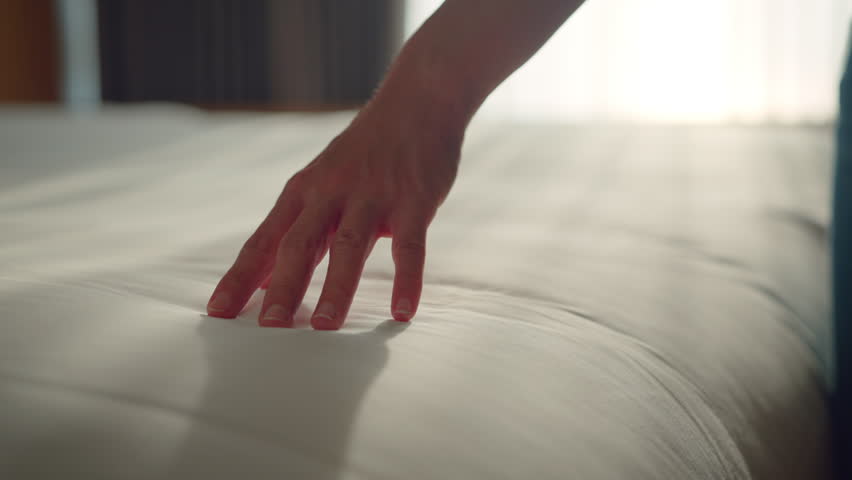 Close up hand of woman dragging on clean white bed gently with relax, Slow motion | Shutterstock HD Video #1102404707