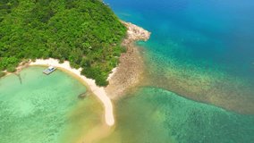 Koh Ma is a stunning island off the coast of Koh Phangan, Thailand. Seen from a drone, its turquoise waters and white sandy beach make for a picturesque view. travel destination concept. 4K HDR
