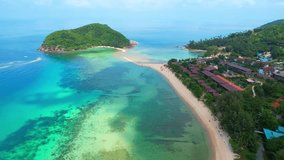 Sandbar connects the small island. It offers stunning views of turquoise waters and white sand beaches. (Koh Ma, Koh Phangan, Thailand). aerial view from drone. nature and travel concept. 4K HDR
