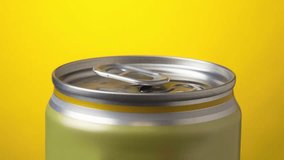 Opening beverage tin can with water drops on yellow background stopmotion animation video