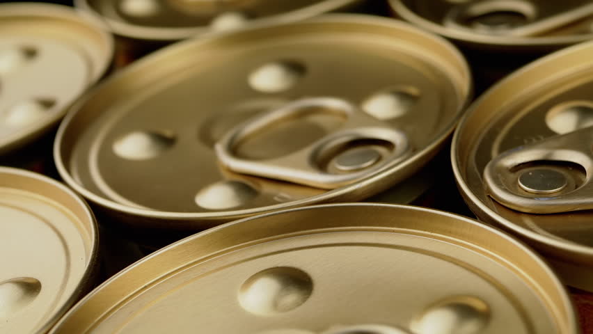 Close up, Slow Rotation of Metal Cans with Canned Food or Pate. Macro. Top view. Closed golden cans with pull rings. Canned tourist food or wet pet food, pate. Military, humanitarian aid to soldiers. Royalty-Free Stock Footage #1102406605