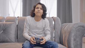 Competitive Indian teenager boy playing video games