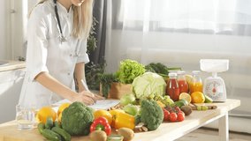 A female nutritionist makes a menu for proper nutrition, there are a lot of vegetables and fruits nearby. In the frame is a woman without a face.