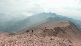 climbers in the mountains. a group of climbers is walking along a mountain range in the mountains of Turkey. Slow motion video. mountain panorama. Mountains of Aladaglar.