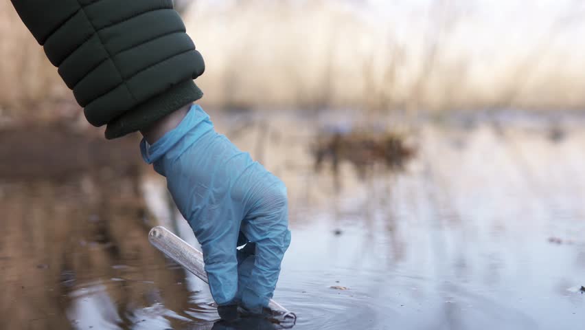 A scientist tests the water for infections and harmful emissions. Ecology of the world water basin.