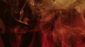 Orange, yellow smoke in the light of different colors on a black background, abstract background, dancing fog. 8K downscale, 4K. - Powered by Shutterstock - Get 15% off with code: PIKWIZARD15