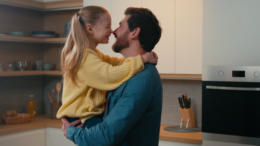 Loving man father holding cute adopted lovely kid daughter touching with noses with child hugging girl at home kitchen bonding hug embracing cuddling together happy family affectionate love cuddle Royalty-Free Stock Footage #1102429679