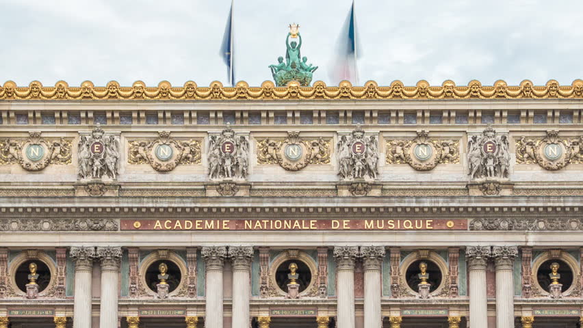 Palais or Opera Garnier The National Academy of Music front view timelapse in Paris, France. People walking around and traffic on the street. Metro entrance.