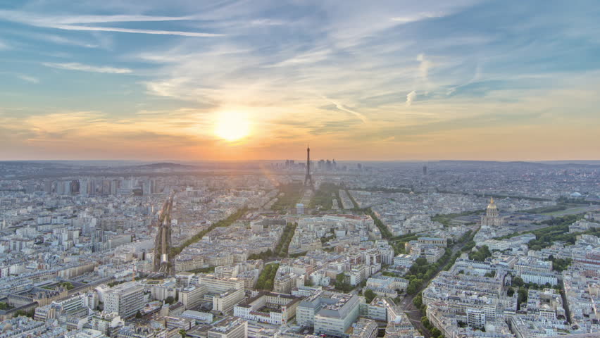 Panorama of Paris at sunset timelapse. Eiffel tower aerial view from observation deck of montparnasse building in Paris - France. Colorful sky at summer day